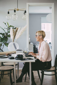 Woman sitting at table working from home