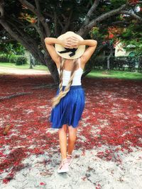 Rear view of woman standing with umbrella