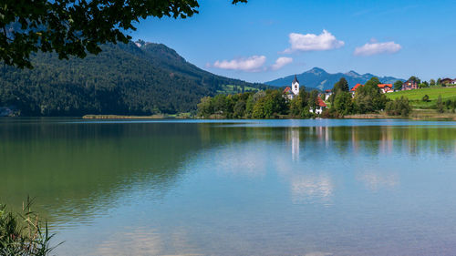 Scenic view of lake and mountains against sky