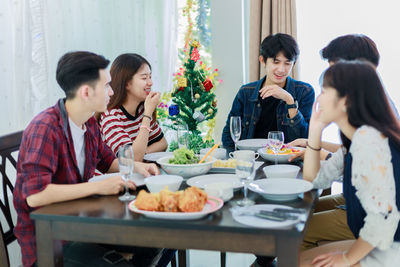 Friends having lunch at home during christmas
