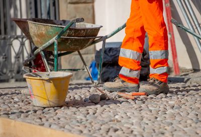 Low section of man working on metal