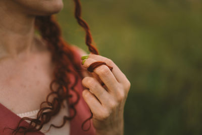 A girl with red curly hair. long hair