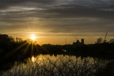 Scenic view of lake against sky during sunset