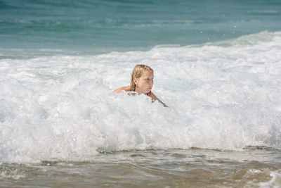 Woman swimming in sea