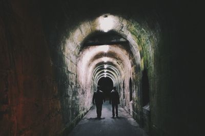 Rear view of woman in tunnel