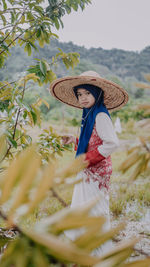 Portrait of girl wearing hat on field