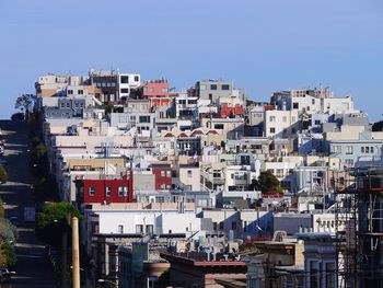 Houses in city against clear sky