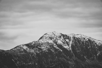 Low angle view of snowcapped mountain against sky