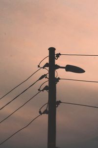 Low angle view of silhouette pole against sky during sunset