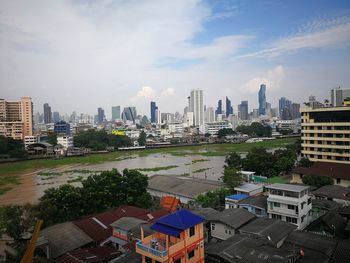 High angle view of buildings in city against sky