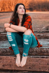 Portrait of young woman sitting outdoors