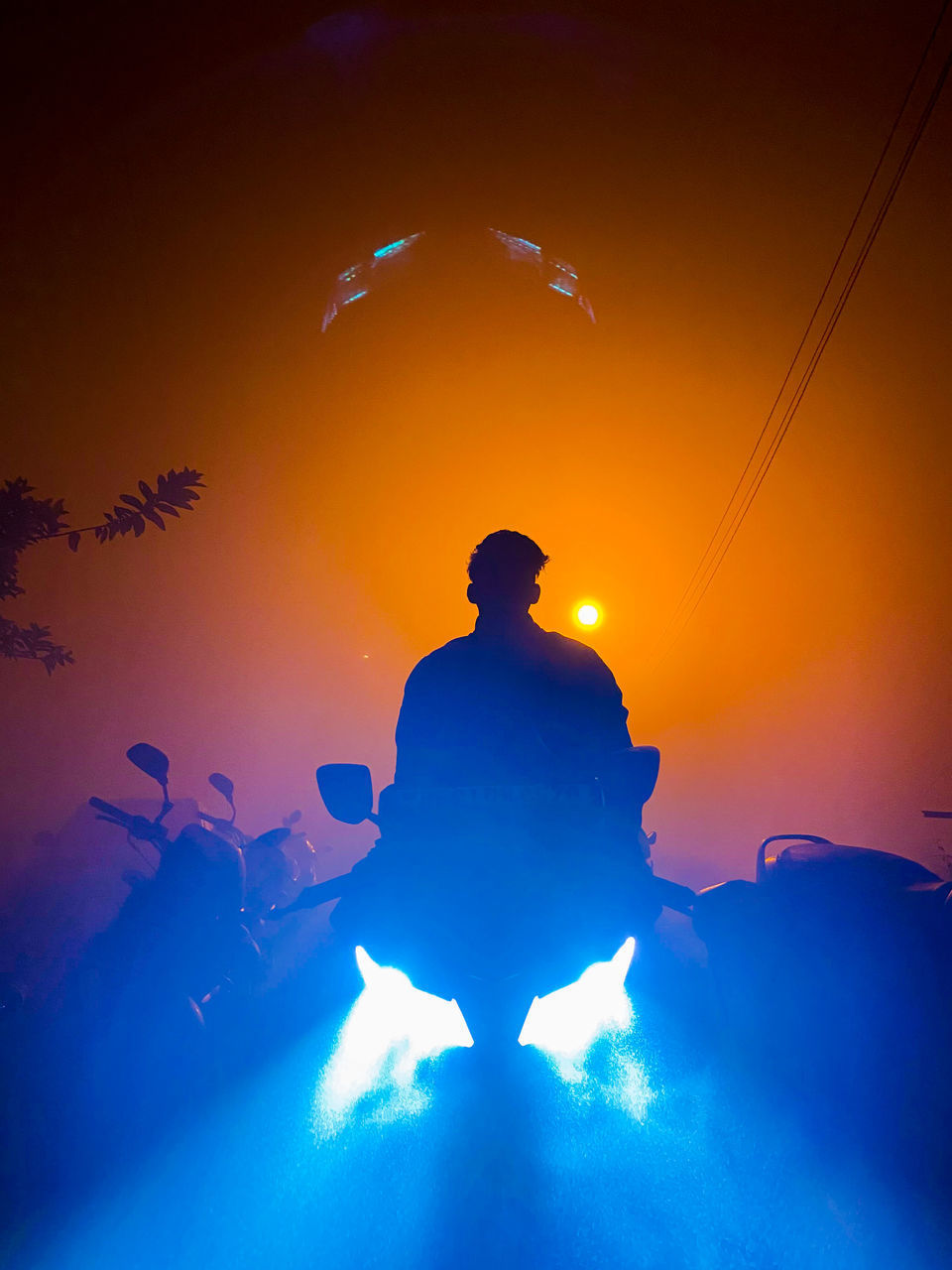 LOW ANGLE VIEW OF SILHOUETTE MAN AGAINST BLUE SKY