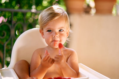 Baby girl eating strawberry