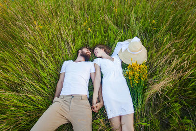 Rear view of couple on field