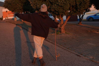 Rear view of men walking on street in city