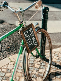 Close-up of bicycle parked against brick wall