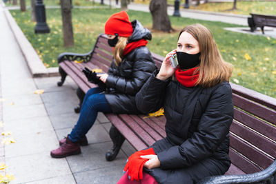 Women sitting on bench in park