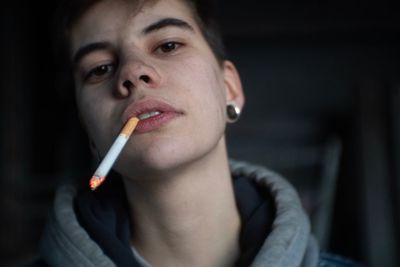 Portrait of mature woman holding cigarette