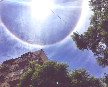 Low angle view of rainbow over house against sky