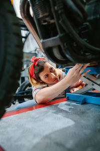 High angle view of young woman sitting in car