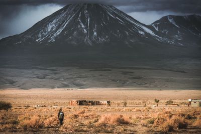 Man standing on field against sky