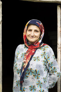 Portrait of a muslim woman in traditional cloth at dark doorway