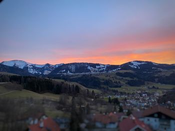 Scenic view of snowcapped mountains against sky at sunset