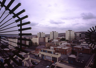 Buildings against cloudy sky