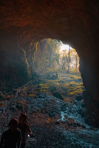 People on rock against mountain