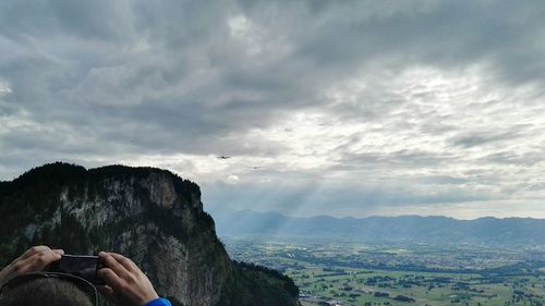 Scenic view of mountains against cloudy sky