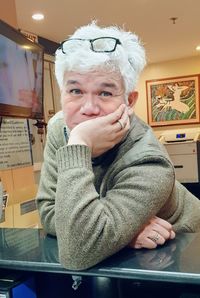 Portrait of woman sitting at home