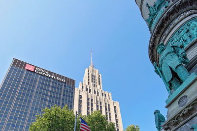 Low angle view of buildings against blue sky