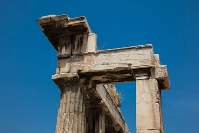 Low angle view of old ruins against blue sky