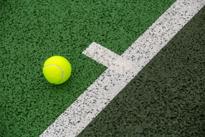 High angle view of yellow ball on green field