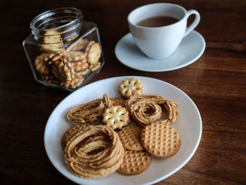 High angle view of evening tea cookies on a wooden table