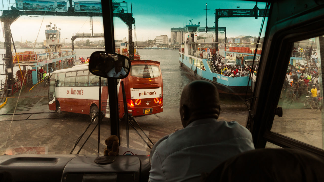 REAR VIEW OF MEN IN BUS