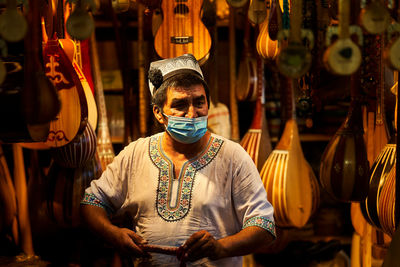 Portrait of young man standing in store