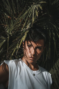 Portrait of young man against plants