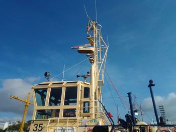 Low angle view of crane against blue sky