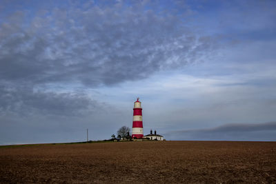 Happisburgh lighthouse on the top of a hill on the coast of norfolk, uk