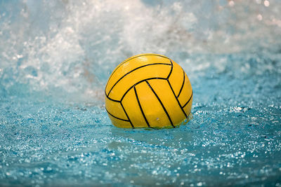 Close-up of yellow ball on water