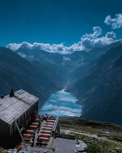 High angle view of sea and mountains against blue sky