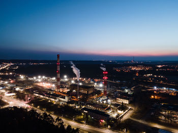 High angle view of city lit up at night