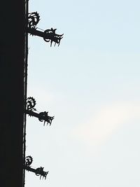 Low angle view of silhouette birds against clear sky