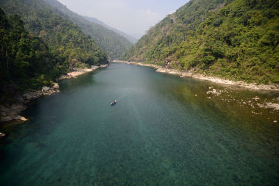 High angle view of river amidst trees and mountains