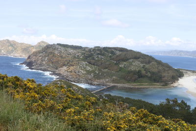 Scenic view of sea and mountains against sky