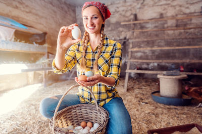Young woman smiling while sitting outdoors
