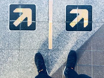 Low section of man standing on street