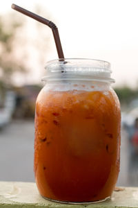 Close-up of drink in jar on retaining wall
