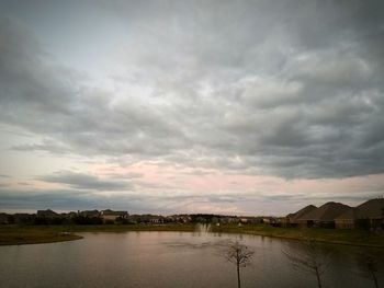 Scenic view of lake against cloudy sky